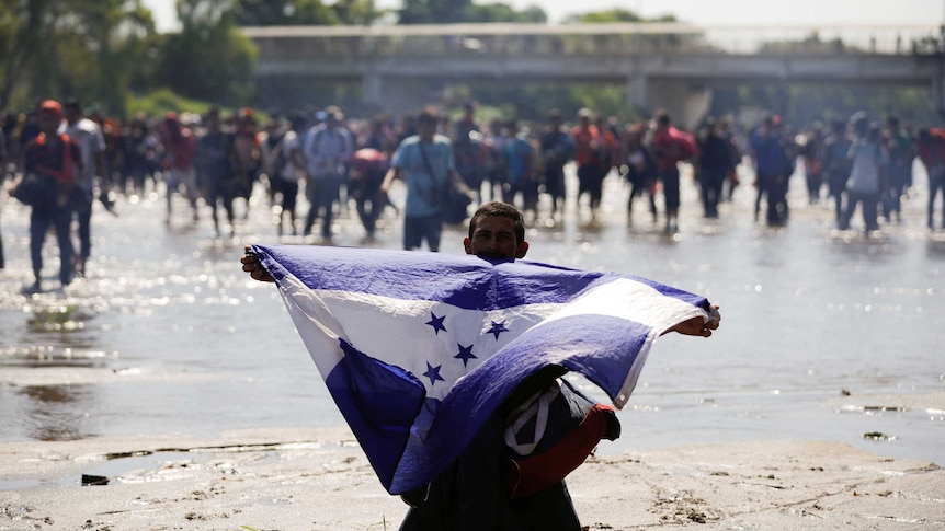 Migrant holds Honduran flag