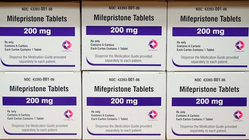 Boxes of Mifeprisone tablets are stacked on top of each other on a shelf