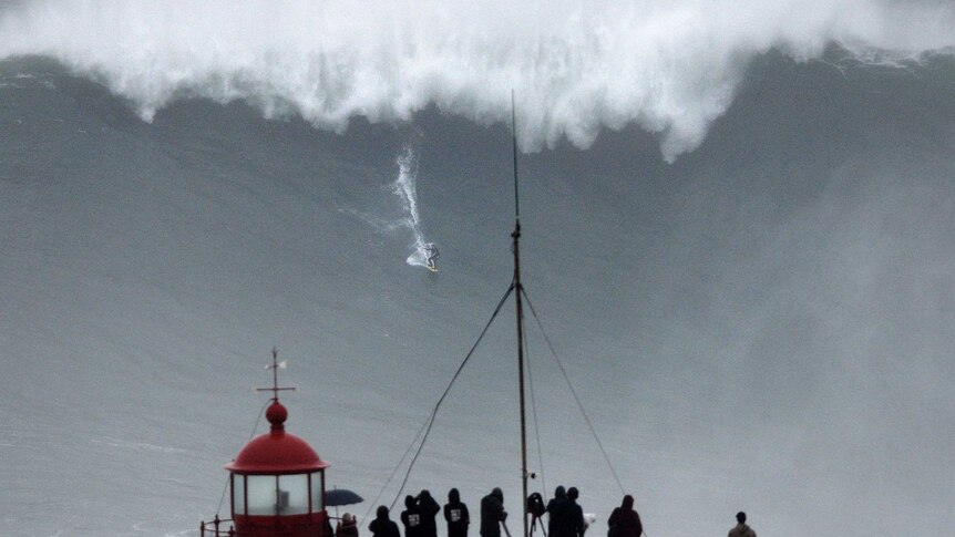 Big wave surfer Carlos Burle rides a wave in Nazare.