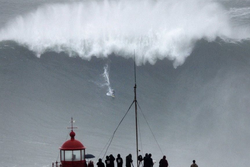 Big wave surfer Carlos Burle rides a wave in Nazare.