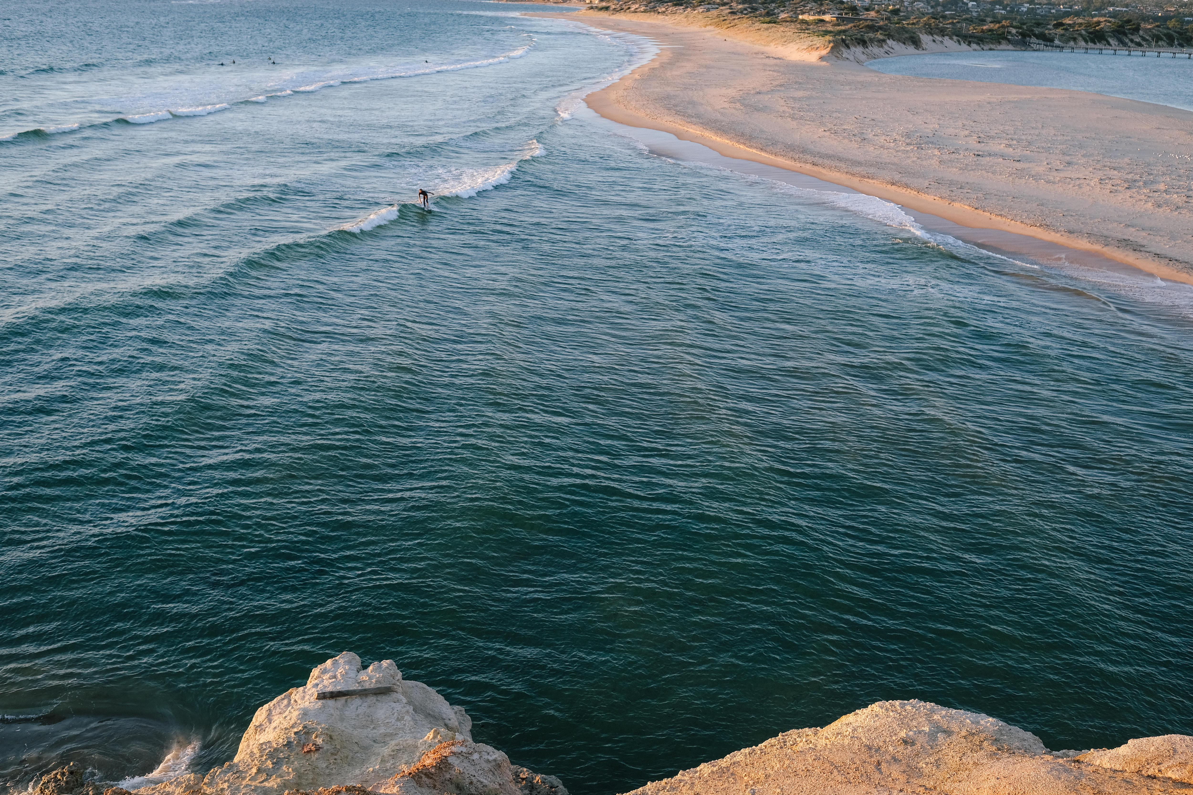 Wide shots of a surf break, with a small surfer in the distance.  