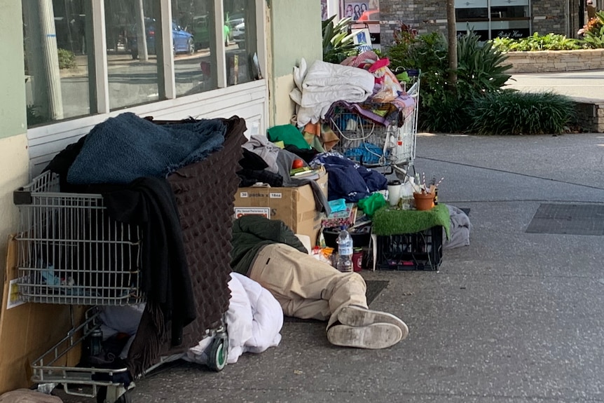 A man suffering homelessness sleeping on a Southport street.