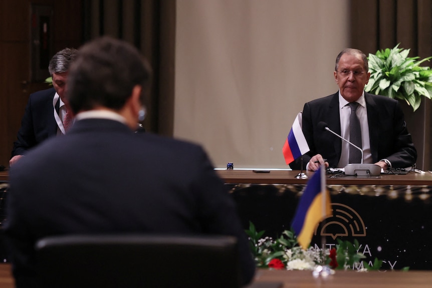 Russian Foreign Minister Sergei Lavrov seen over the shoulder of his Ukrainian counterpart at the negotiating table.