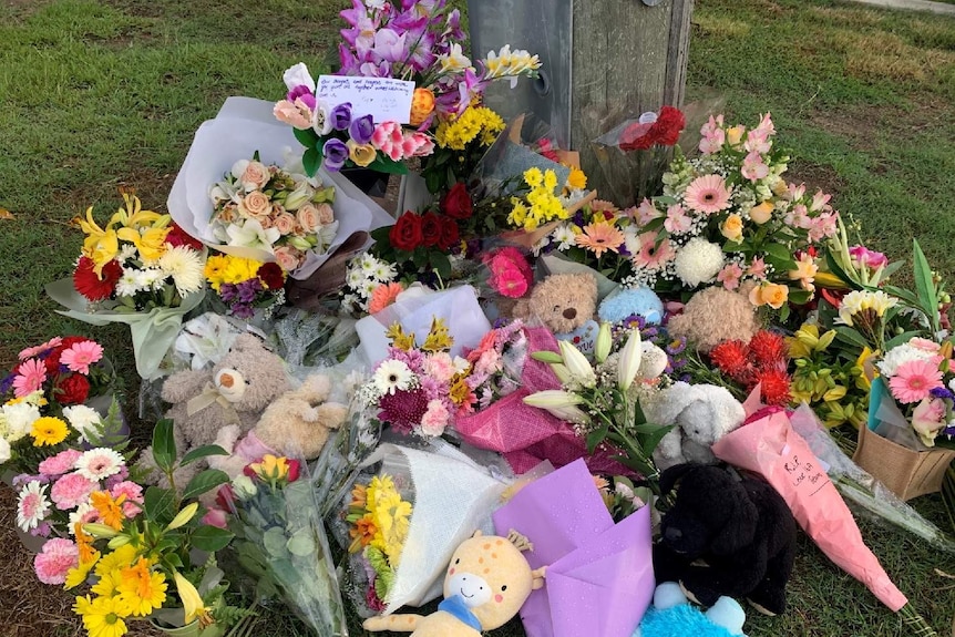 Flowers have been left for the slain mother and children in the Brisbane suburb of Camp Hill.