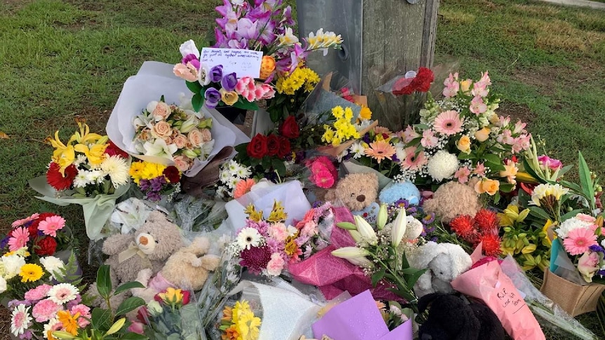 Flowers have been left for the slain mother and children in the Brisbane suburb of Camp Hill.