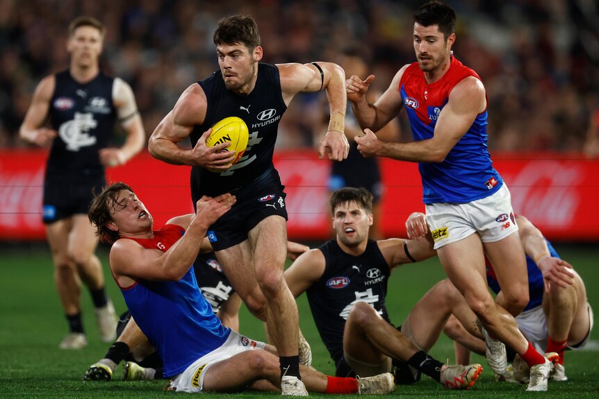 Melbourne, Australia. 02nd June, 2023. Alex Cincotta of Carlton tackles  Kysaiah Pickett of Melbourne during the AFL Round 12 match between the  Melbourne Demons and the Carlton Blues at the Melbourne Cricket