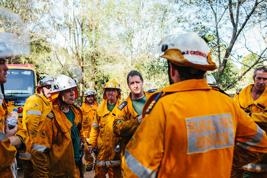 Rural fire fighters plan their next move away from the fire scene.