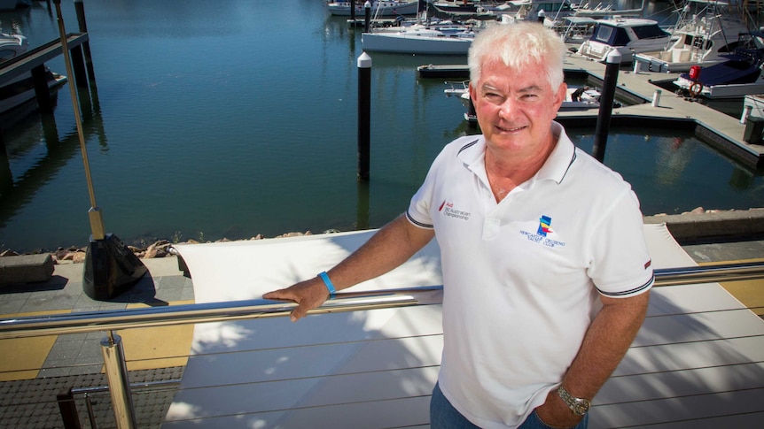 Howard Keegan stands next to a railing.