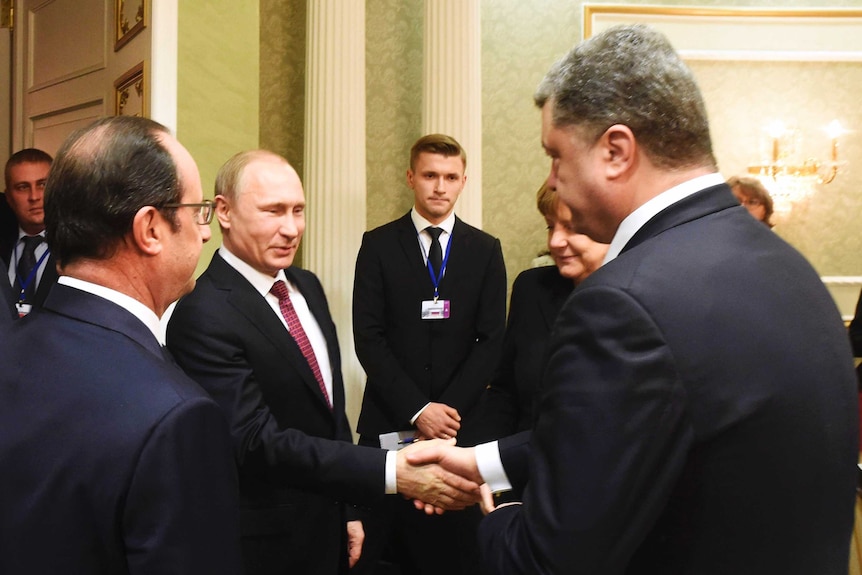Vladimir Putin shakes hands with his Ukrainian counterpart Petro Poroshenko on February 11.