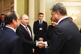 Russian president Vladimir Putin shakes hands with his Ukrainian counterpart Petro Poroshenko