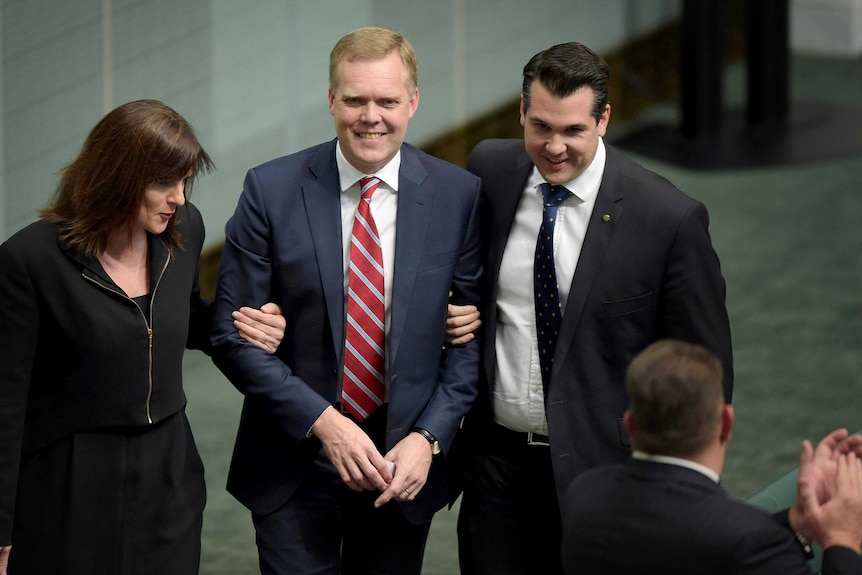 Tony Smith is led to the Speaker's chair in the House of Representatives.