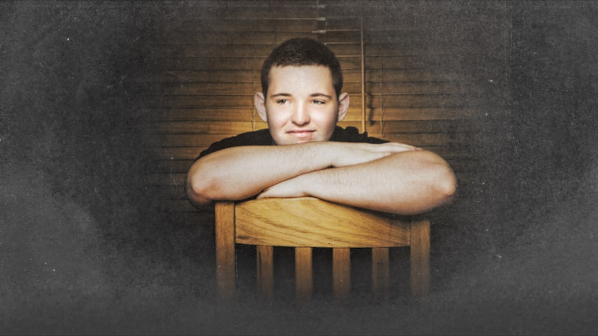 A young man smiling in a portrait.