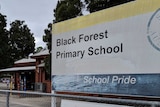A fence and sign outside a primary school.