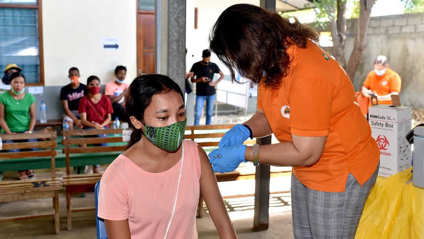 A woman receives a vaccination in Timor-Leste.
