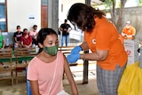 A woman receives a vaccination in Timor-Leste.