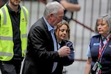 Ian Jamieson is led from a police van in handcuffs outside the Victorian Supreme Court.