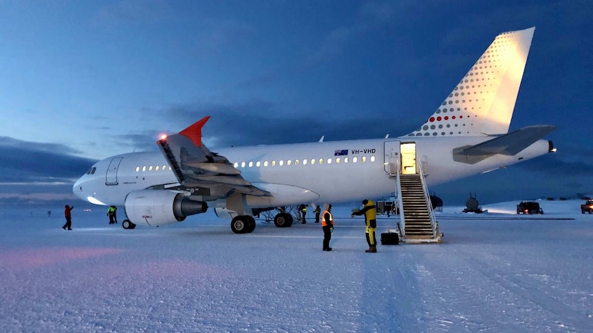Large aircraft parked on ice runway.