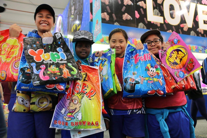 A group of young kids holding Ekka showbags