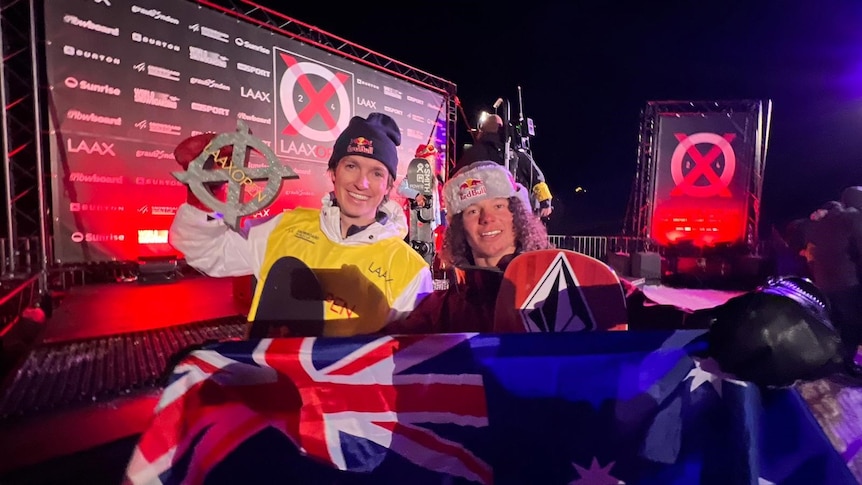 Scotty James and Val Guseli hold an Australia flag