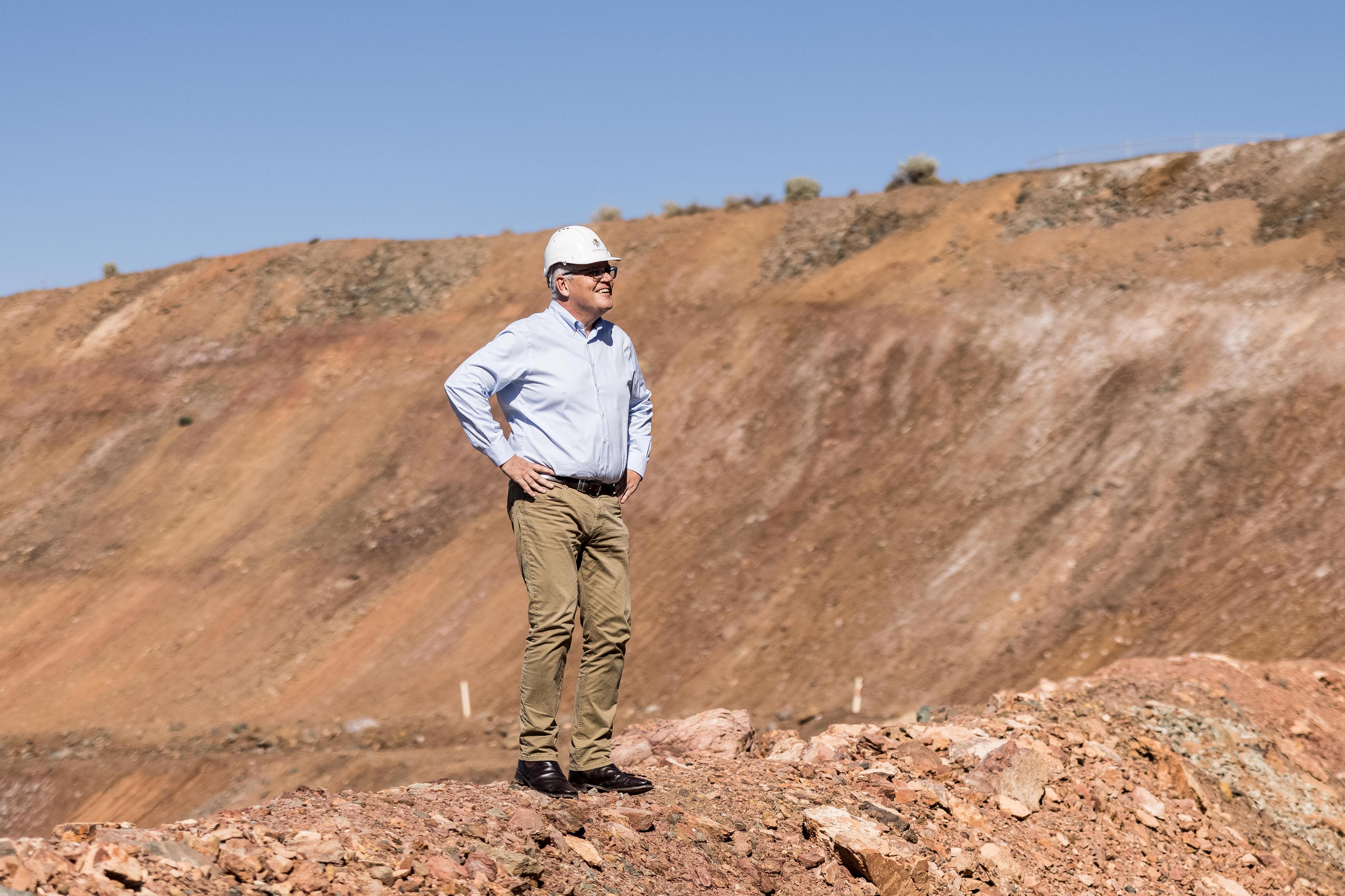 Prime Minister Scott Morrison posing for a photograph at a gold mine. 