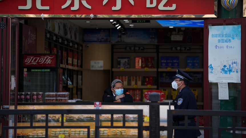 Two people sit at a counter at an empty restaurant