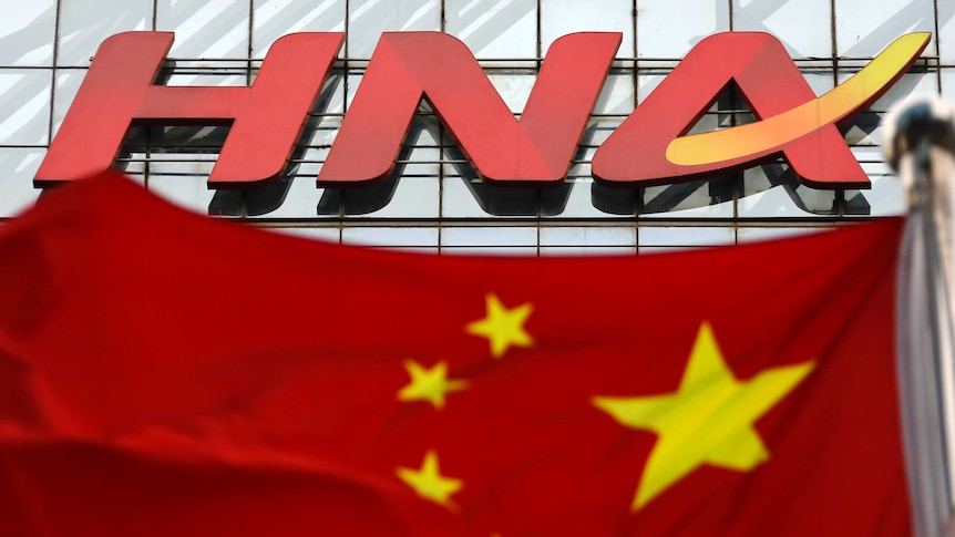 Chinese conglomerate HNA sign sits above the Chinese flag.