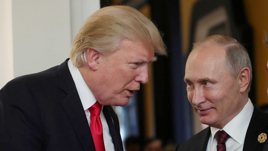 US President Donald Trump talking to a smiling Russian President Vladimir Putin.