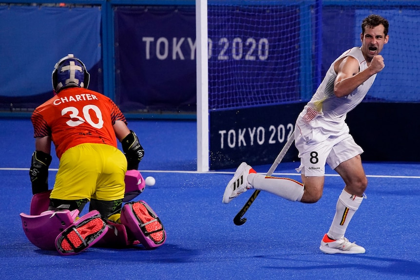 A Belgium men's hockey player pumps his first after scoring against Australia in a shootout.