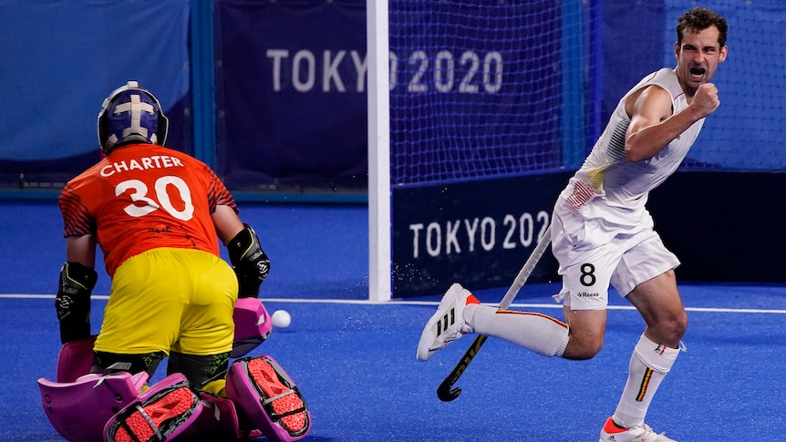 A Belgium men's hockey player pumps his first after scoring against Australia in a shootout.