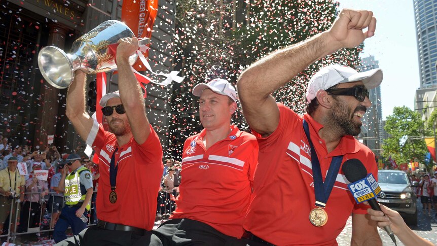 Swans show off the AFL trophy during their victory parade