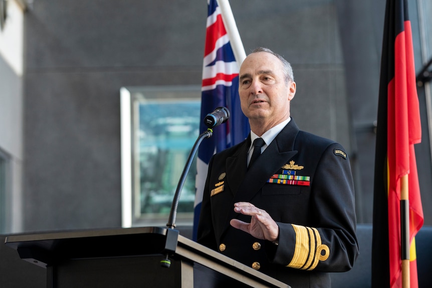 David Johnston, wearing military dress, delivers a speech