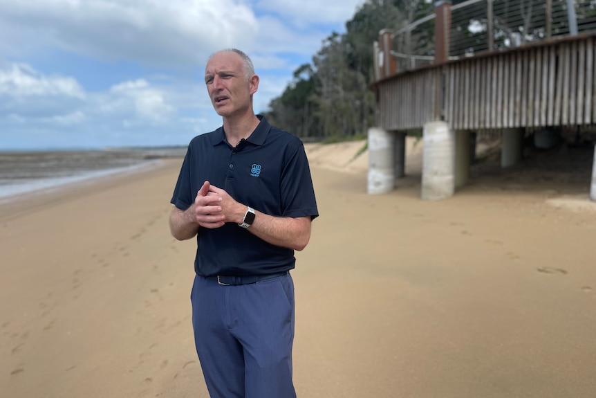 Middle ages man standing on beach at Hervey Bay Esplanade 