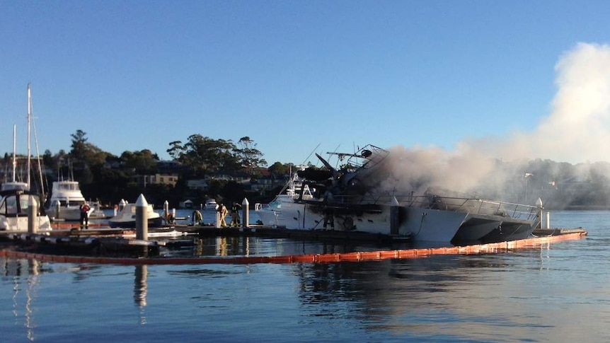 A yacht smoulders after a massive blaze engulfed several boats at Cabarita in Sydney, on December 2, 2013.