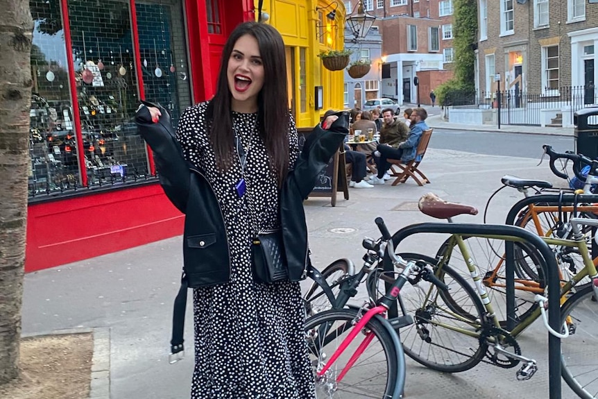 A woman standing next to bikes.