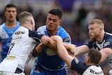 Samoa's Spencer Leniu runs into English defenders during their Rugby League World Cup pool match.