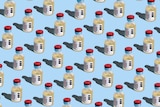 Repeated covid-19 vaccine vials on a blue background.