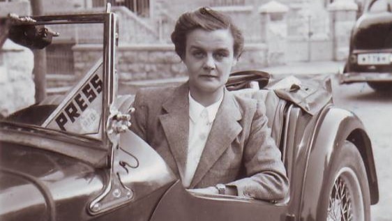 Journalist Clare Hollingworth in a car marked "press".