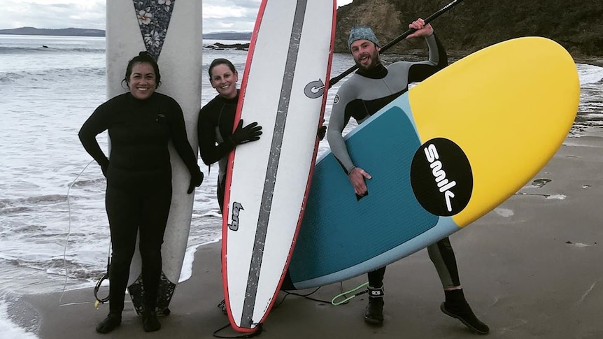 Charley Rico has started a surf club with her neighbours Brooke (middle) and Hugh (right) at Tasmania's Park Beach