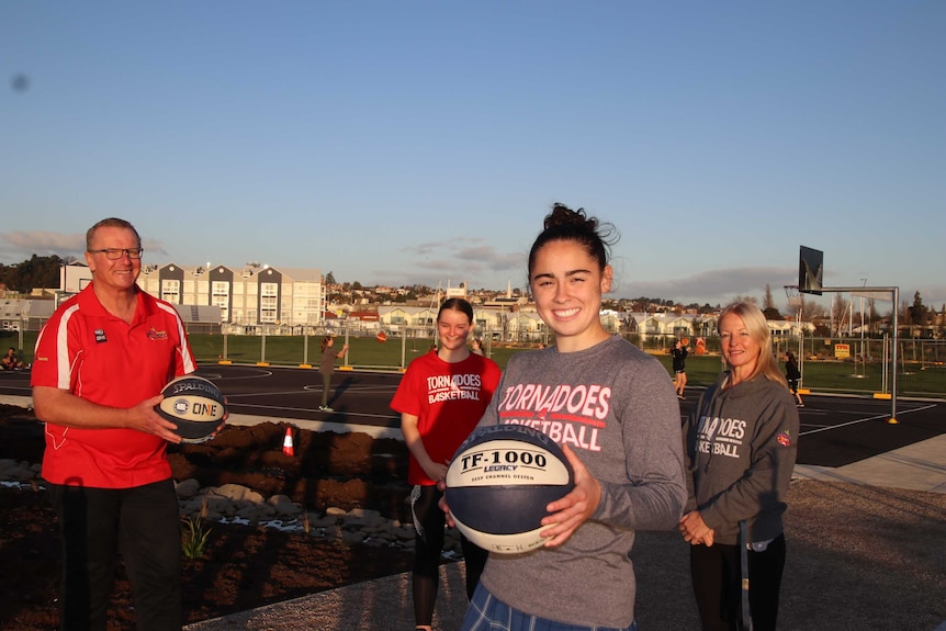 Launceston tornadoes chairman Neil Grose, players Aishah Anis and Micah Simpson and coach Sarah Veale on Riverbend Park courts