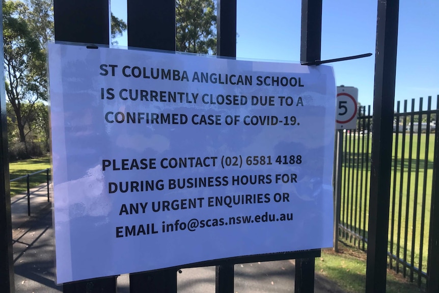 Sign on closed school gate confirmed covid-19 case