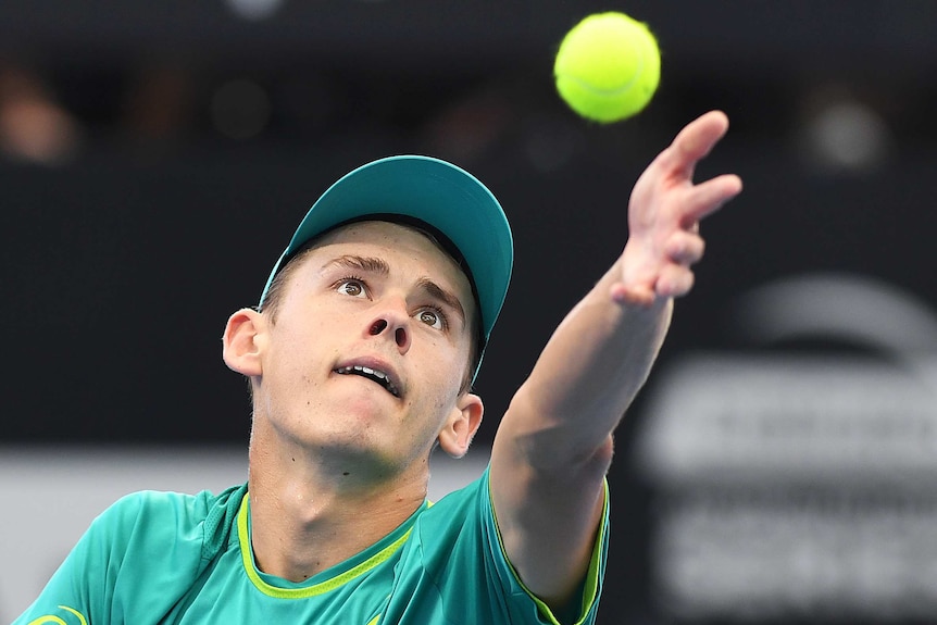 Alex De Minaur holds up the ball as he is about to serve at the Brisbane International.