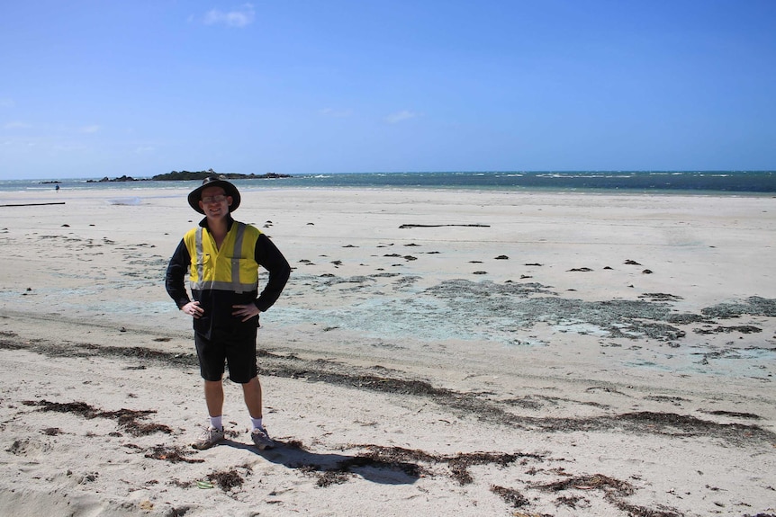 Mathew Townsend stands for a photo on Chilli Beach