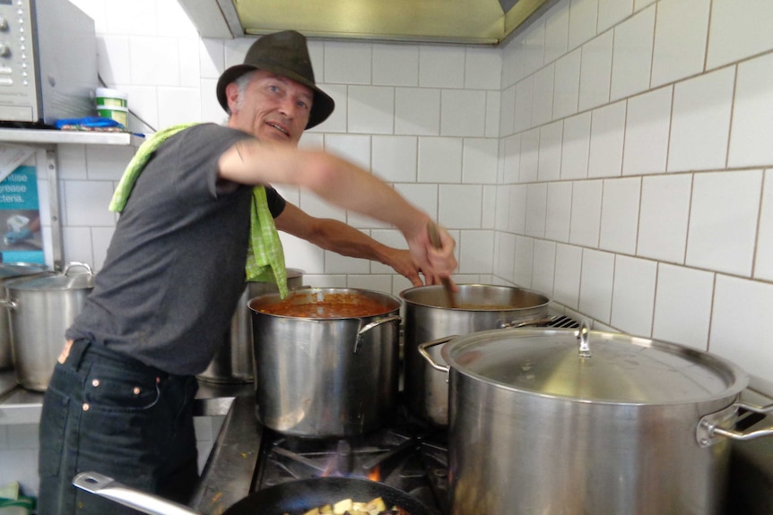 A man with a soup pot .