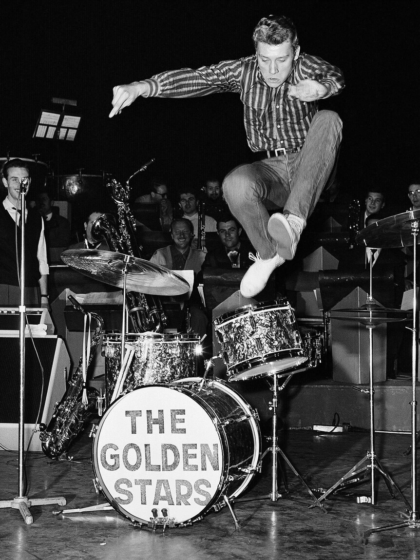 French pop singer Johnny Hallyday leaps into the air while rehearsing at the Olympia Theatre in Paris