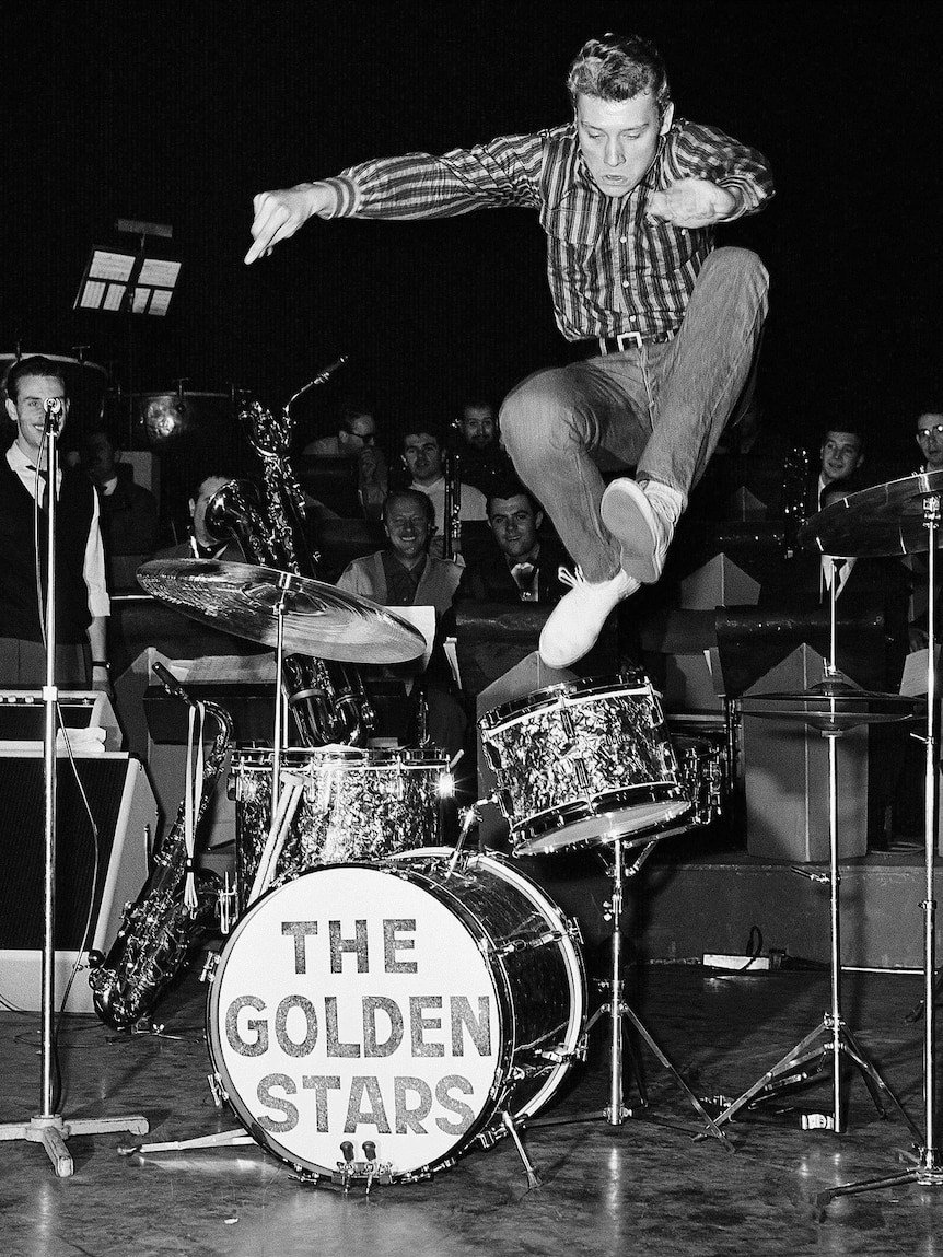 French pop singer Johnny Hallyday leaps into the air while rehearsing at the Olympia Theatre in Paris