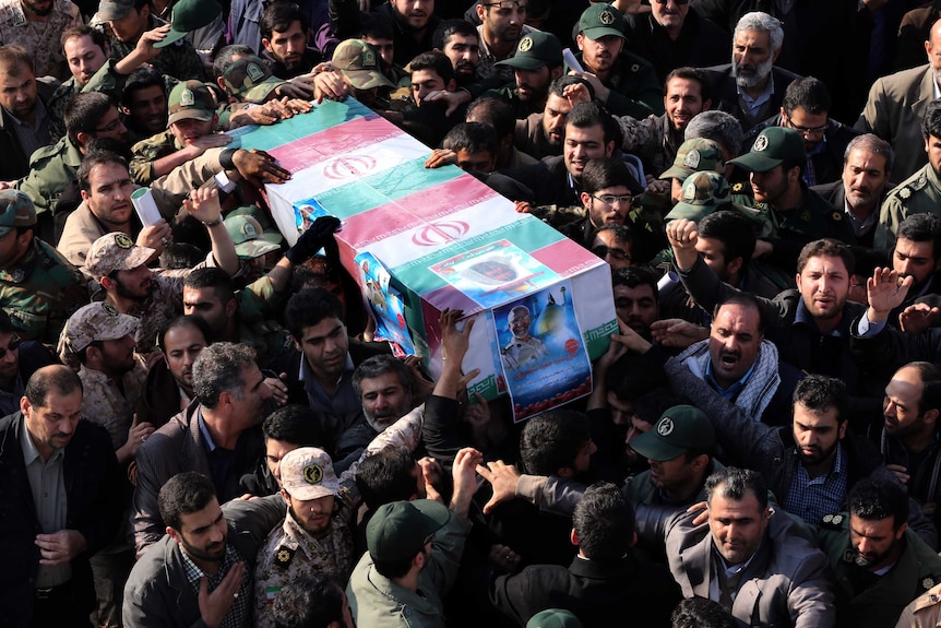 Iranians carry the coffin of Brigadier General Hamid Taghavi