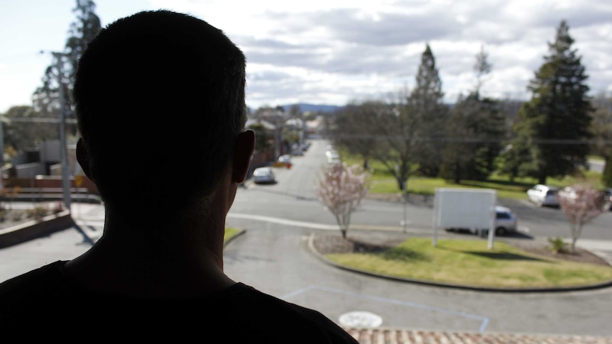 A man looking out a window