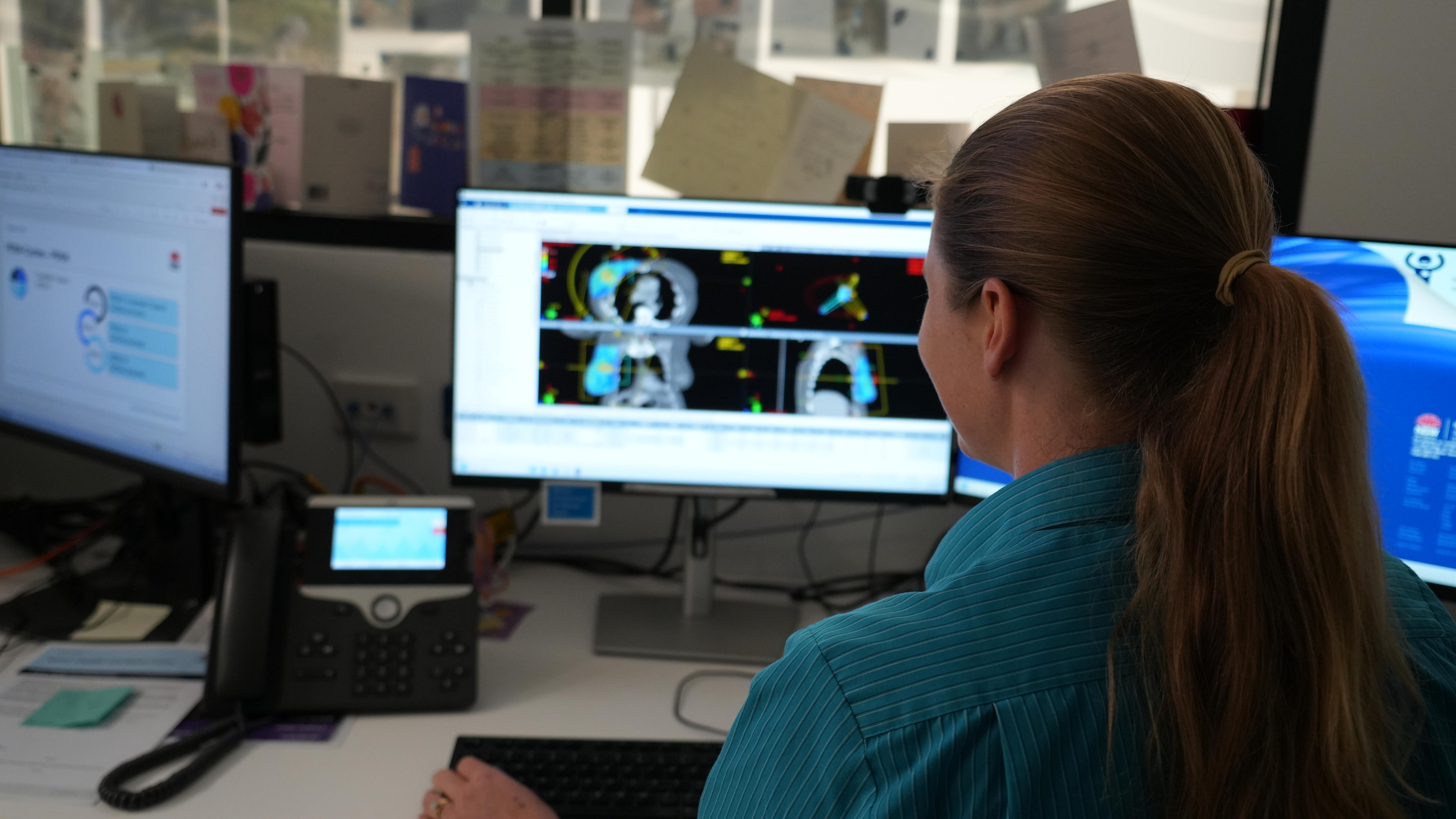 A hospital staff member looking at computer screen