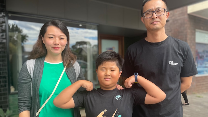 A child with his mother and father.