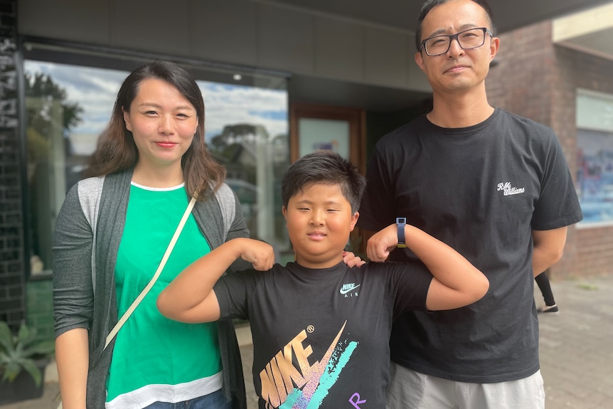 A child with his mother and father.